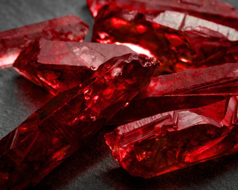A close up picture of some large red transluscent gemstones